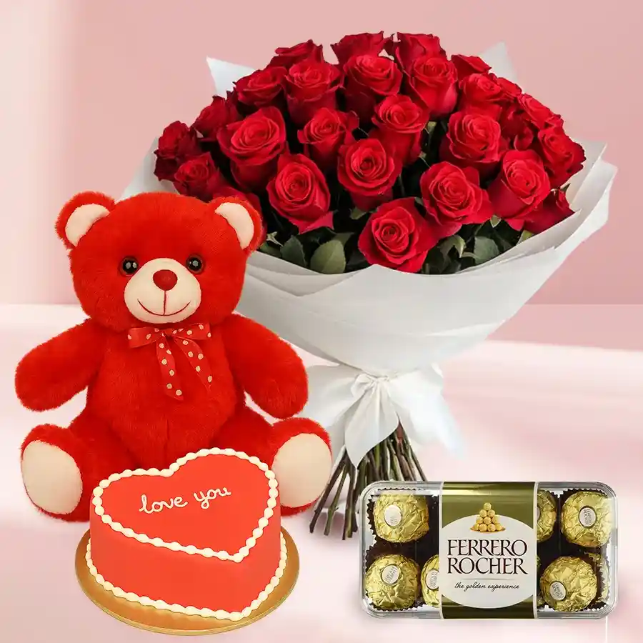 Heartfelt gift set featuring red roses, a heart-shaped chocolate cake, Ferrero Rocher chocolates, and a red teddy bear.
