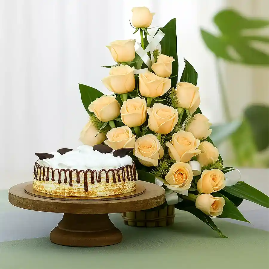 A beautiful basket of peach roses accompanied by a delicious round butterscotch cake.