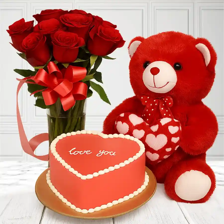 Heartfelt combo of red roses, heart-shaped chocolate cake, and a teddy bear holding a heart.