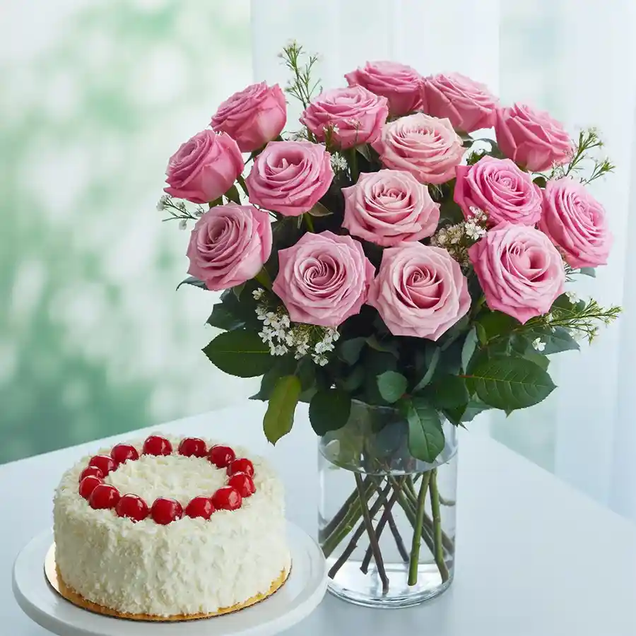 Charming pink roses in a vase paired with a round White Forest Cake.