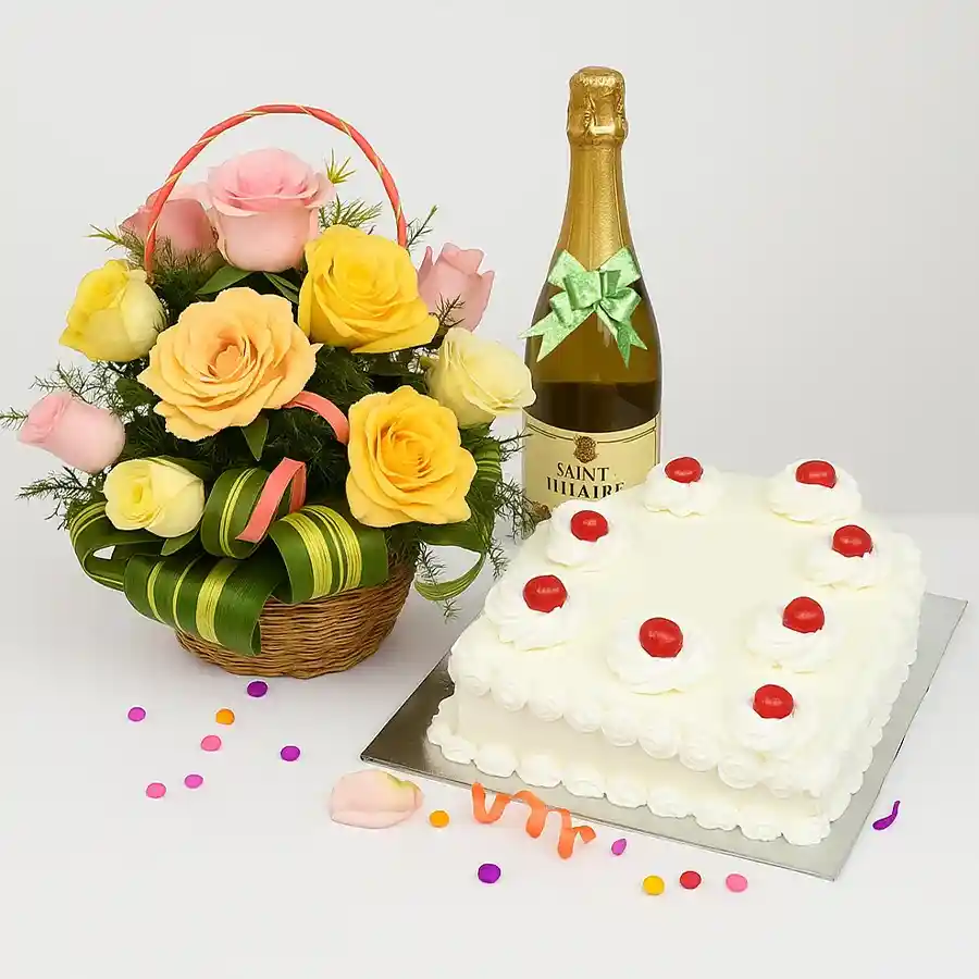 Joyful basket featuring mixed roses, a square White Forest cake, and a bottle of sparkling fruit juice for a festive celebration.