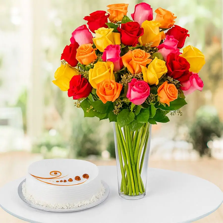 A vibrant arrangement of 24 mixed roses in a vase paired with a round vanilla cake, perfect for gifting on special occasions.