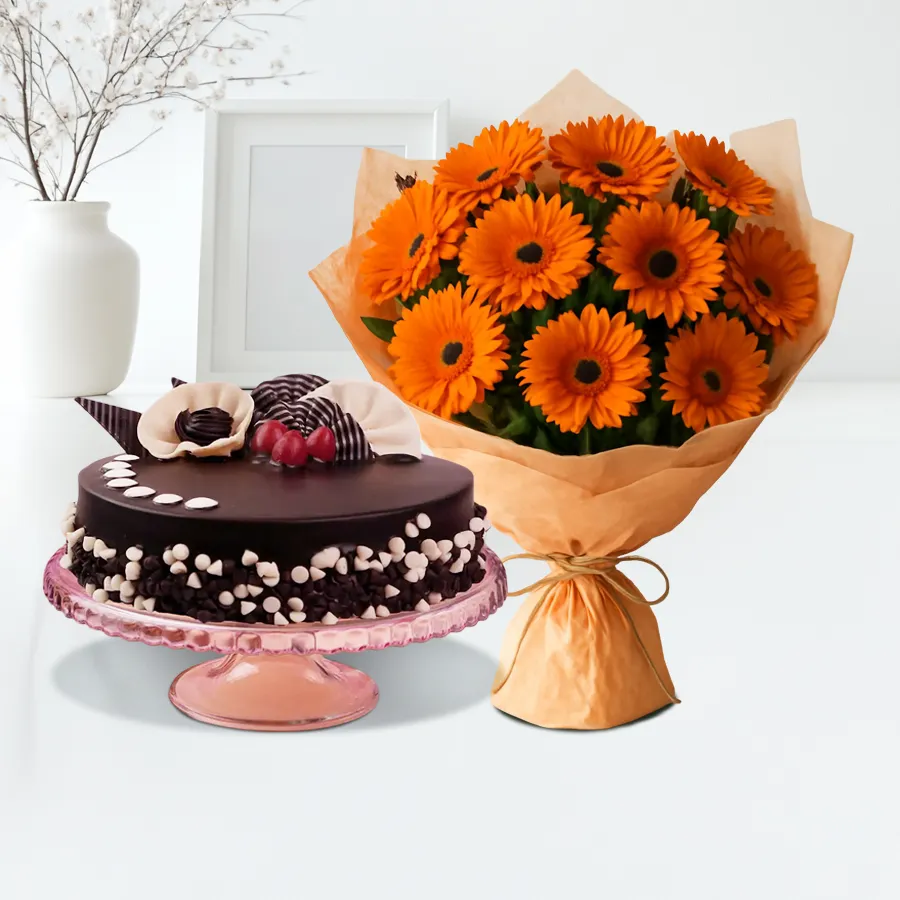 Cheerful orange gerberas bouquet paired with a round chocolate cake for a joyful gift combo.