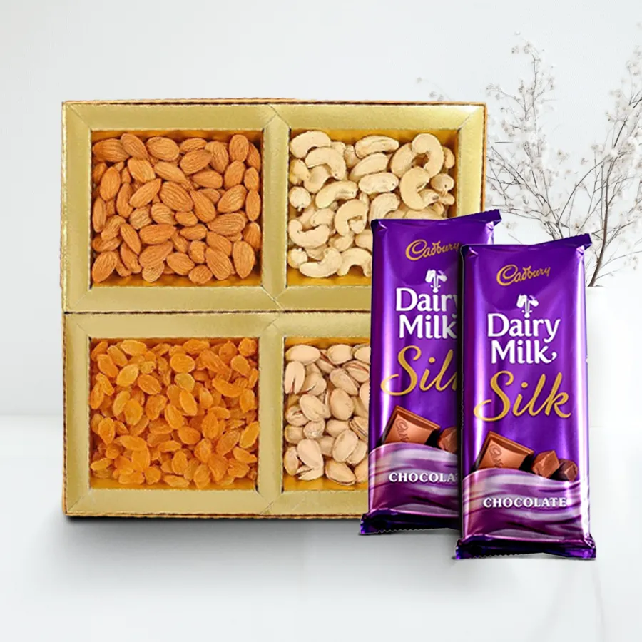 Gourmet gift box featuring assorted dry fruits and Cadbury Dairy Milk Silk chocolate, ideal for gifting.