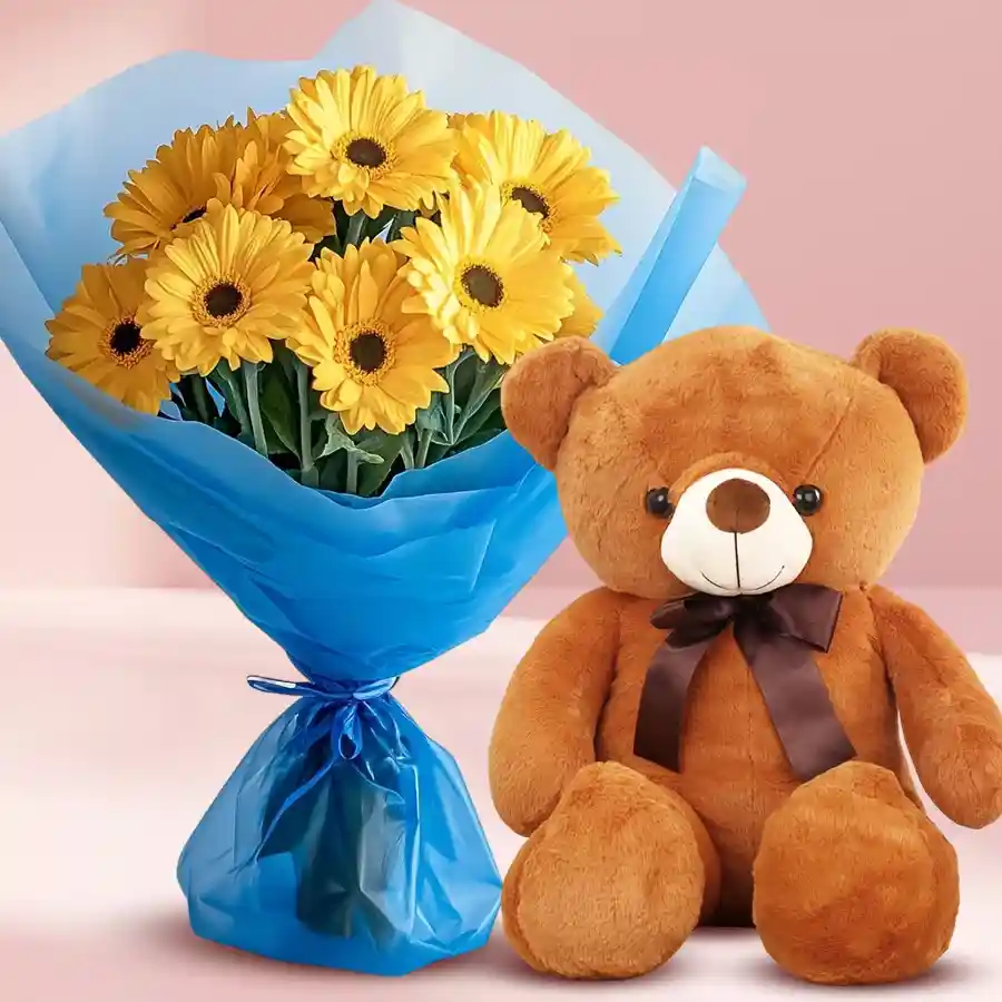 Cheerful bouquet of yellow gerberas with a cute brown teddy bear.