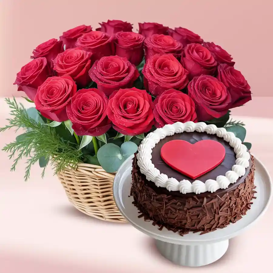 A beautiful basket of red roses and a Black Forest cake with a red heart topping in a celebratory combo.