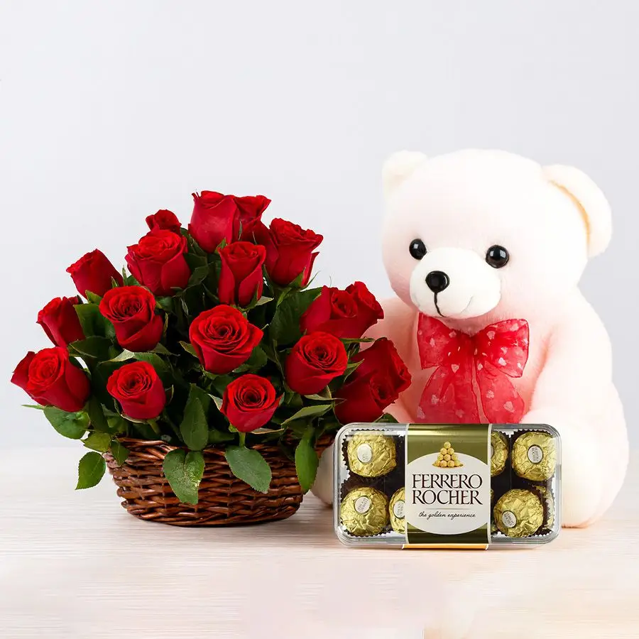 Romantic red roses arrangement with Ferrero Rocher chocolates and a flirty pink teddy bear.