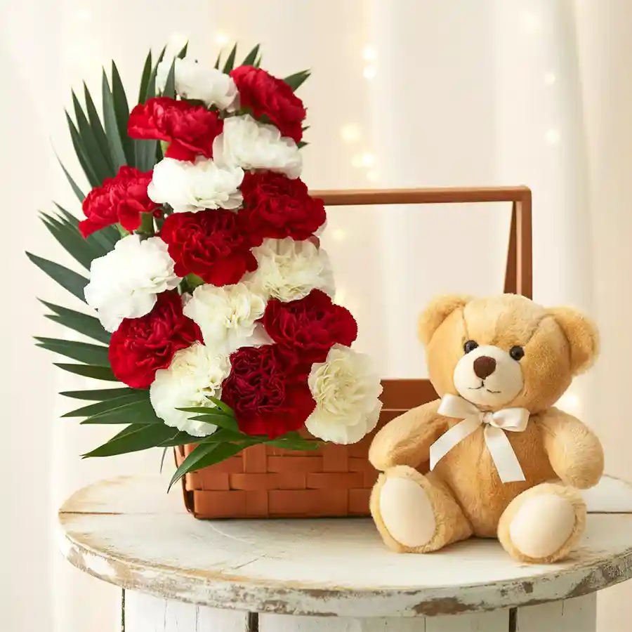 Adorable bouquet of red and white carnations with a cute brown teddy bear.