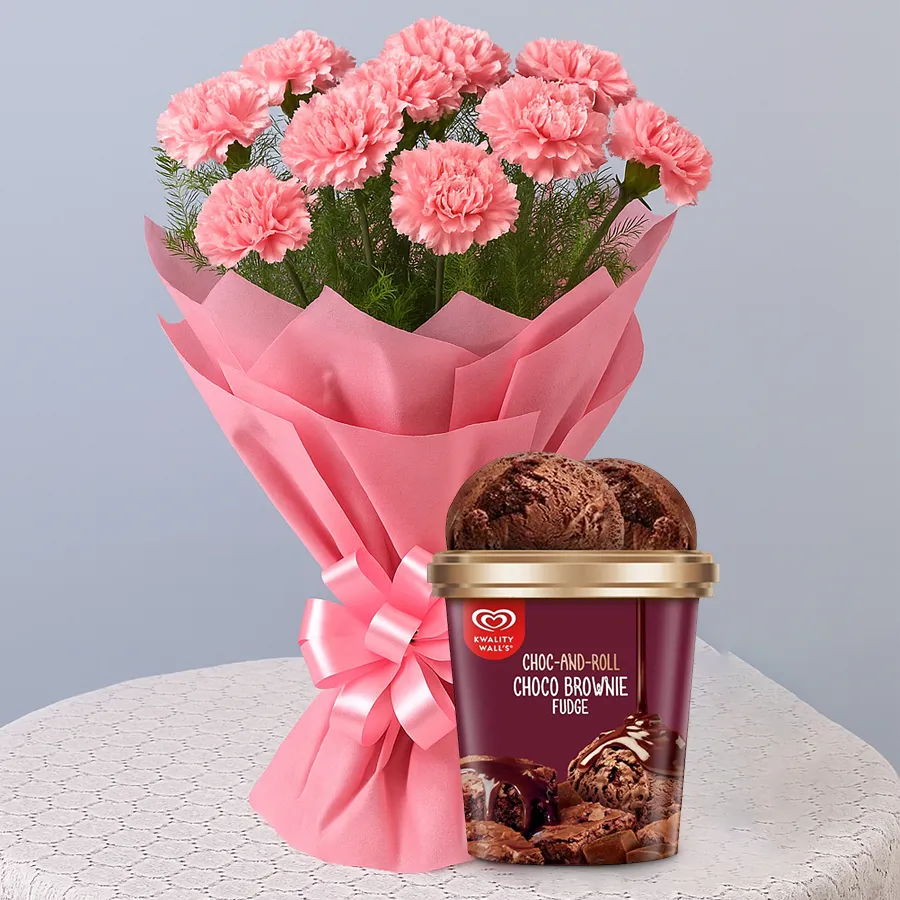 A vibrant bouquet of pink carnations alongside a tub of Choco Brownie Fudge Ice Cream from Kwality Walls.