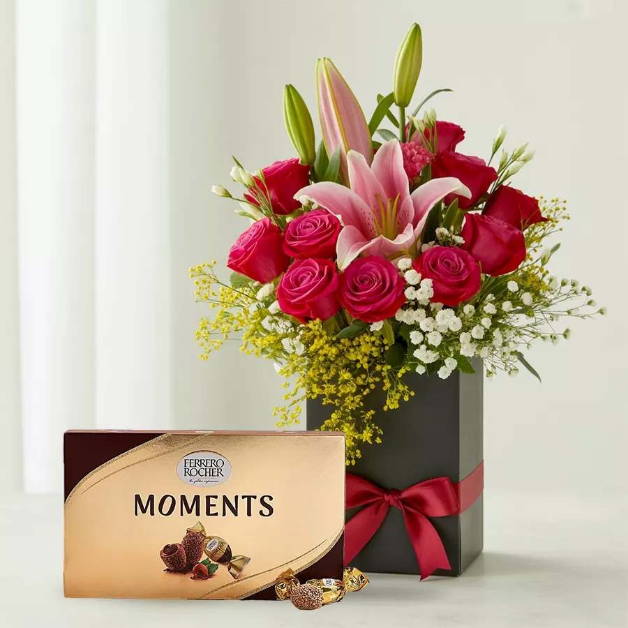 Gift box featuring 12 red roses, 3 pink lilies, and Ferrero Rocher chocolates, ideal for Mother's Day celebrations.