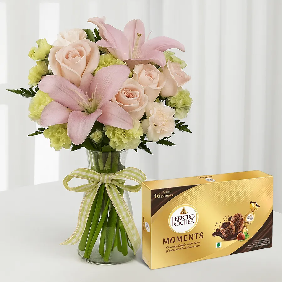 Chic floral bouquet with pink roses, lilies, and Ferrero Rocher chocolates.