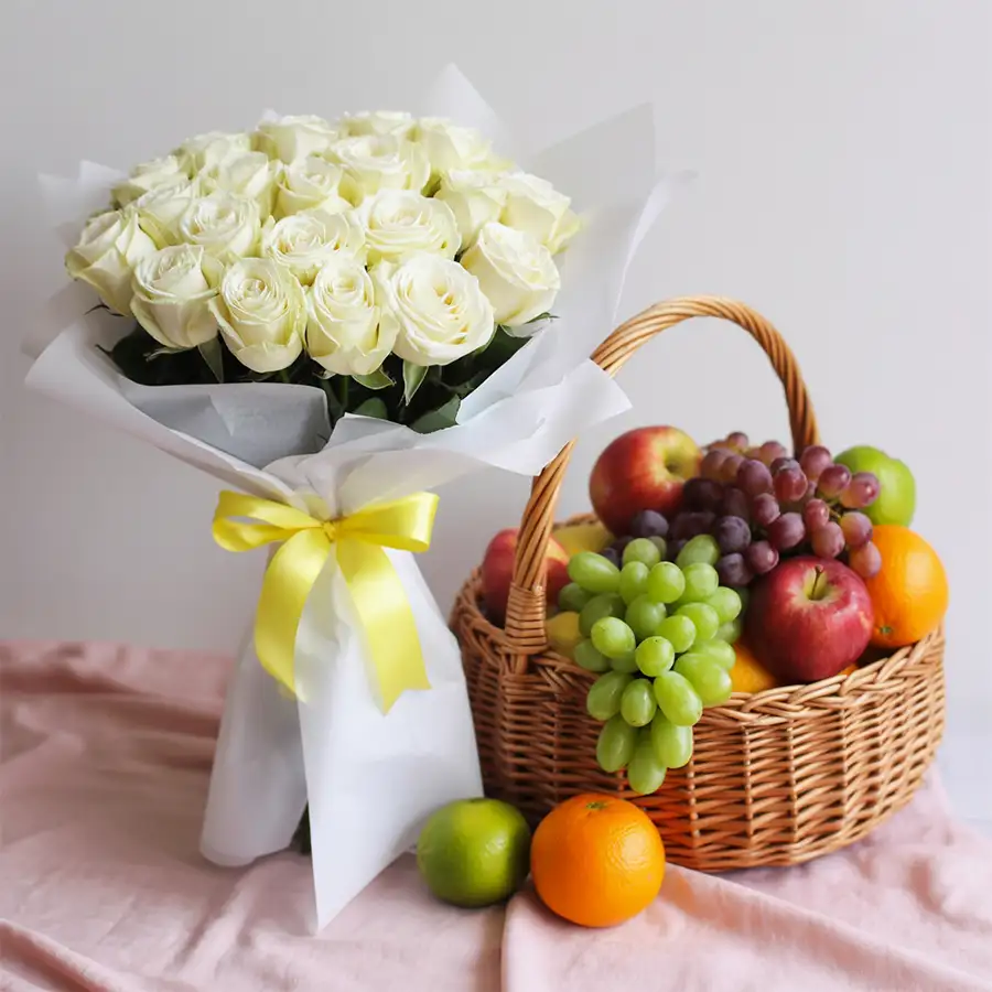 Elegant bouquet of white roses with fresh fruits in a charming arrangement.