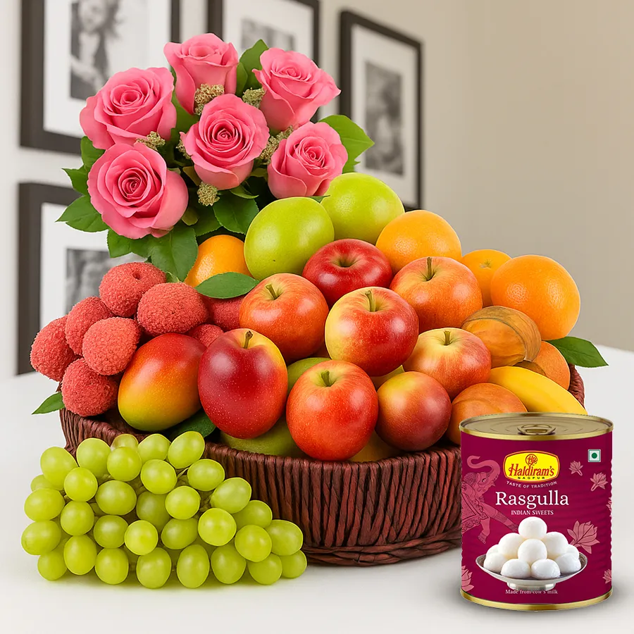 A beautiful gift basket featuring fresh fruits, Haldiram's Rasgulla, and pink roses, perfect for celebrating mom.