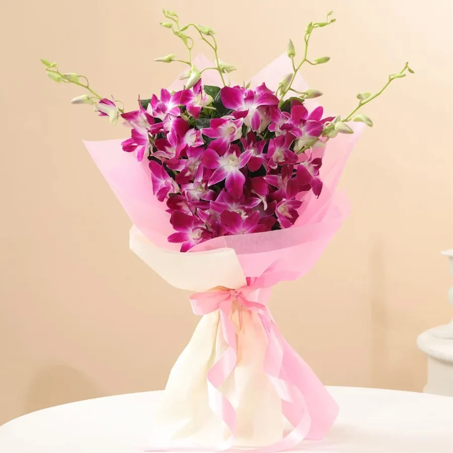 A stunning bunch of purple orchids elegantly wrapped in a pink satin ribbon, perfect for expressing heartfelt sentiments on special occasions.