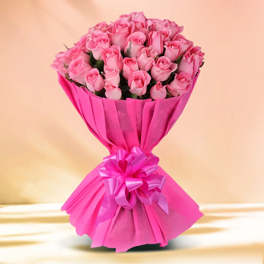 A charming bouquet of 8 pink roses elegantly wrapped in tissue, perfect for expressing love and admiration.