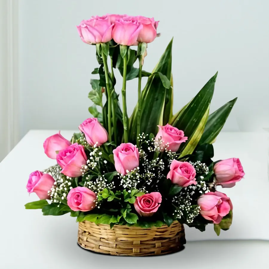 Exquisite arrangement of 18 pink roses in a charming round basket.