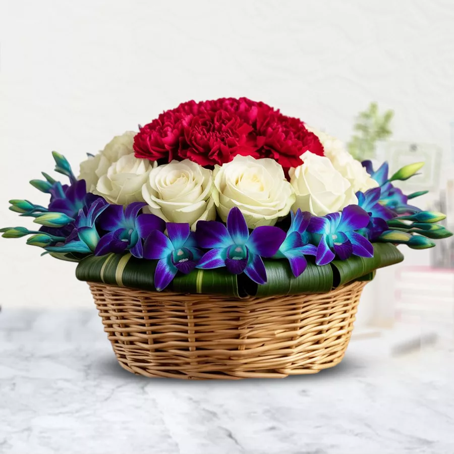 Heartfelt Mother's Day floral basket with pink carnations, white roses, and blue orchids.