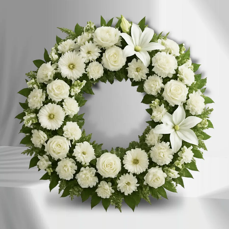 Elegant Floral Tribute Wreath made of 70 white flowers including roses, carnations, daisies, and lilies.