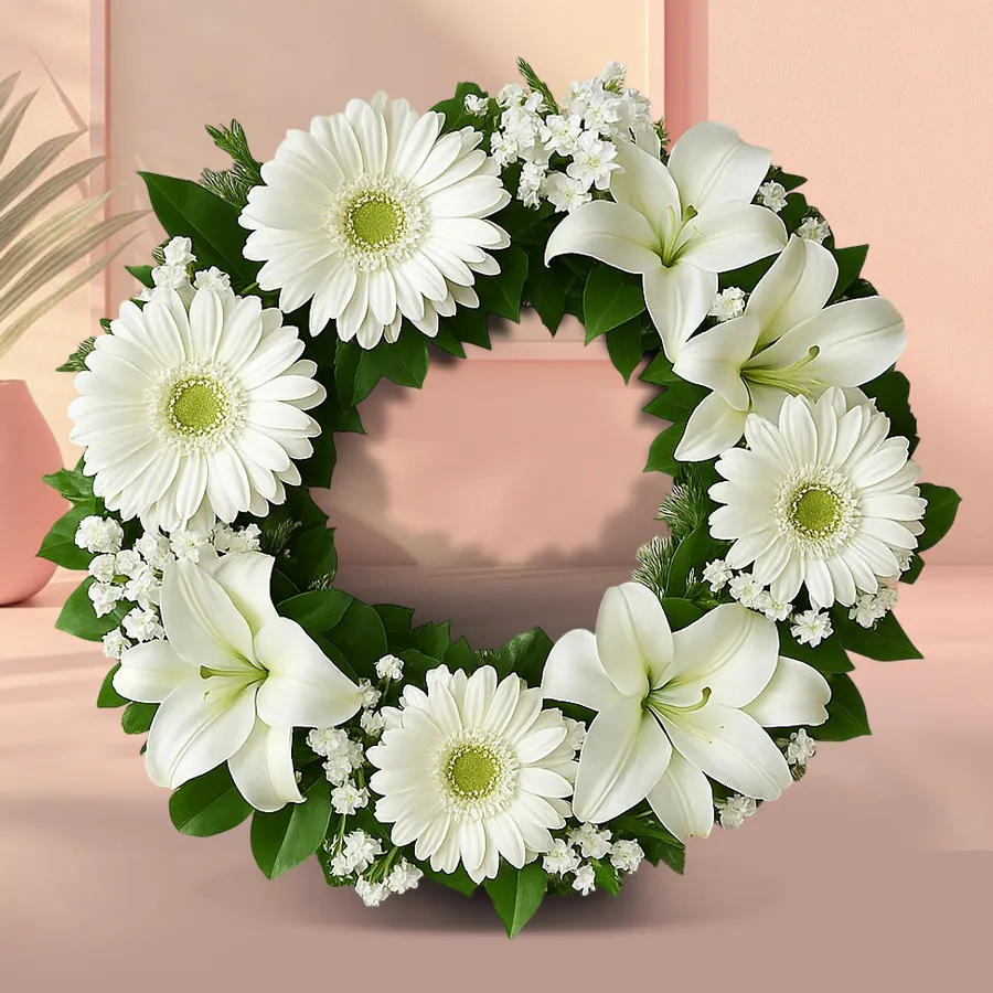 Beautiful white gerberas and lilies in a serene remembrance floral wreath.