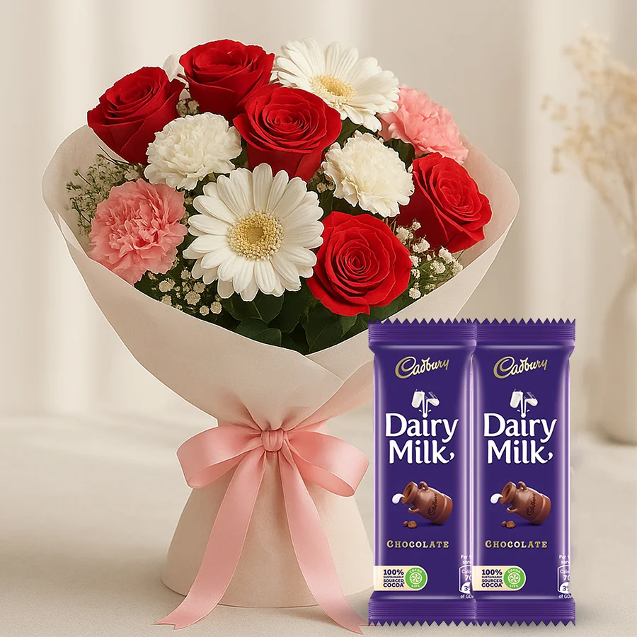 Rhapsodic Blossom Olio floral arrangement with roses, carnations, gerberas, chic ribbon, petite fillers, and Dairy Milk chocolates.