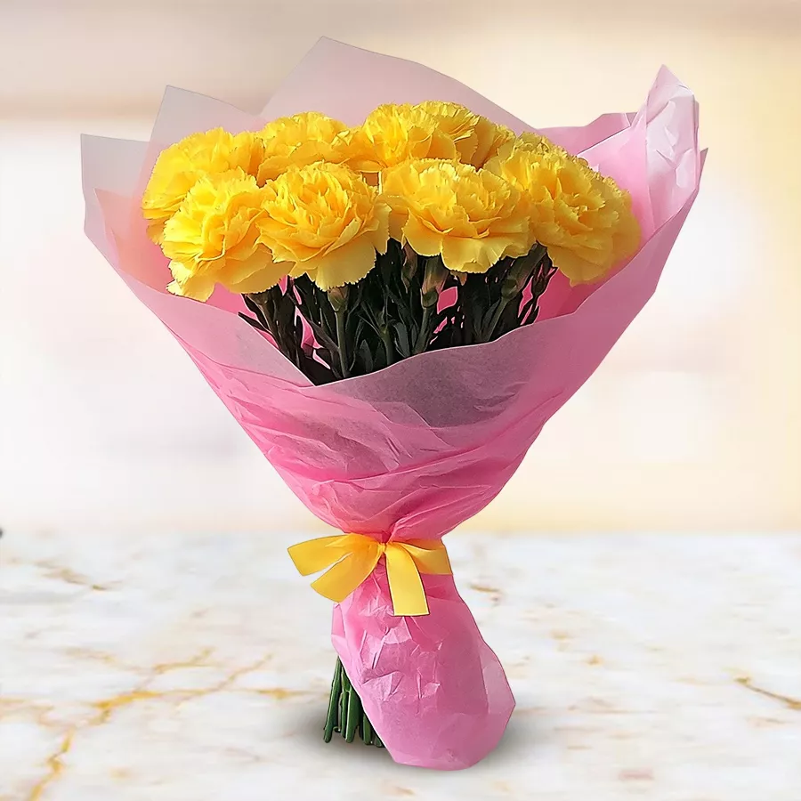 Bouquet of 10 yellow carnations tied with tissue, ideal for gifting.