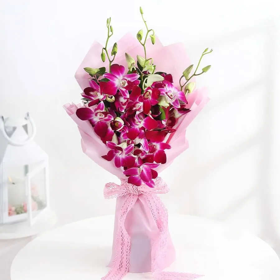 Orchid Splendor bouquet featuring eight elegant orchid stems wrapped in tissue and tied with a ribbon.