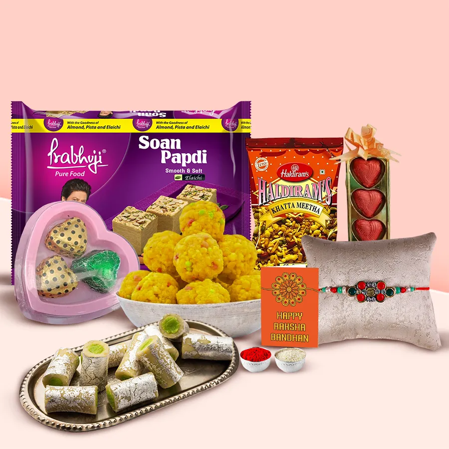 Haldirams Grace of Gratification Collection hamper featuring Soan Papdi, Khatta Meetha Mixture, Kaju Pista Roll, Thandai bottle, homemade chocolates, and heart-shaped treats