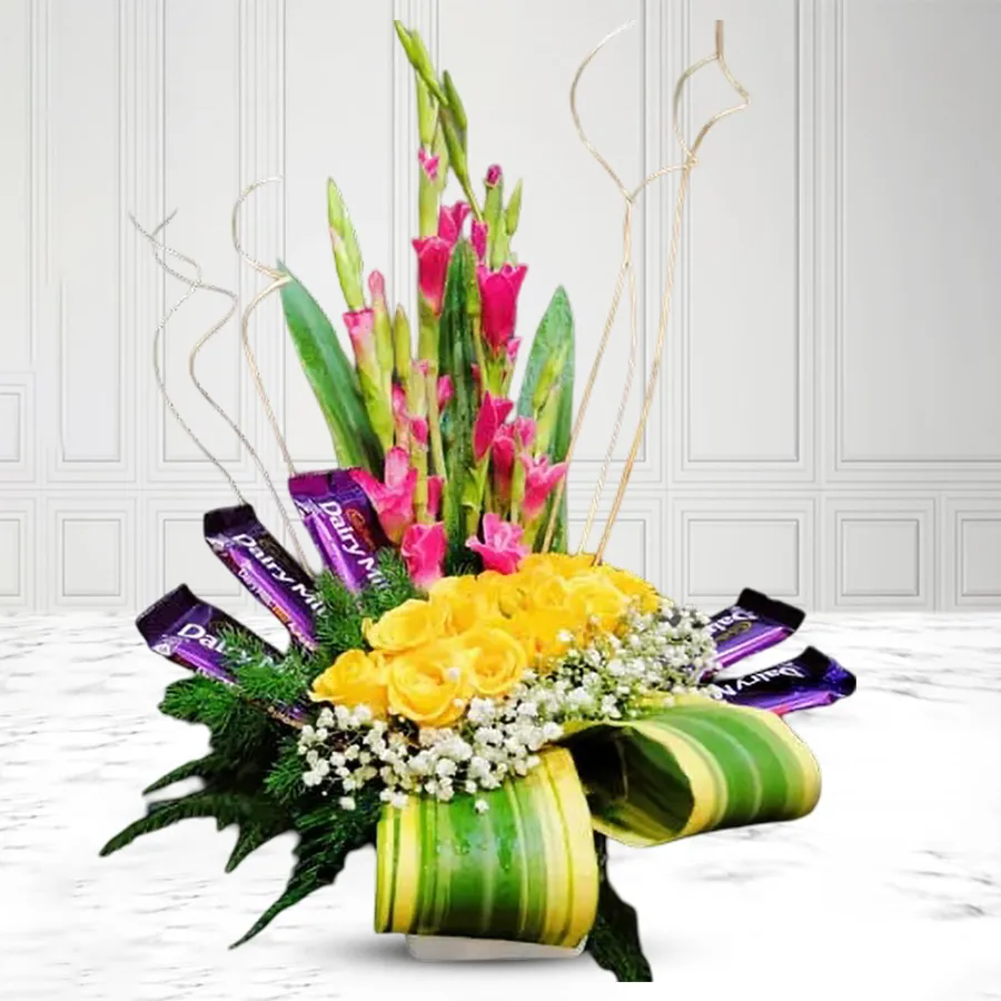 An elegant arrangement of yellow roses, pink gladiolus, gypsy flowers, and Cadbury chocolate bars, perfect for gifting.