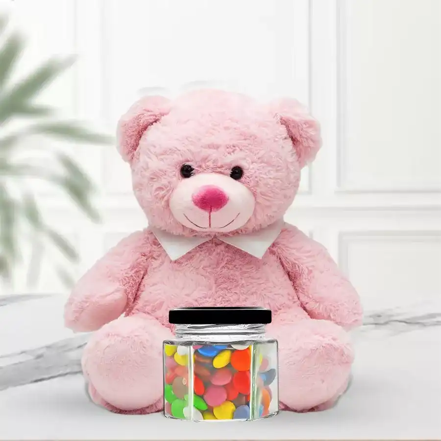 6-inch teddy bear sitting next to colorful Cadbury Gems in an airtight glass jar