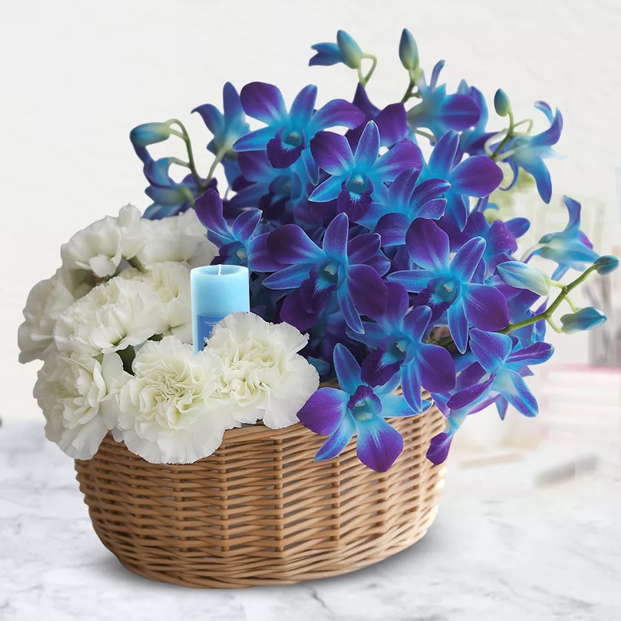 Luminous Floral Elegance Arrangement with 8 carnations, orchids, and a candle.