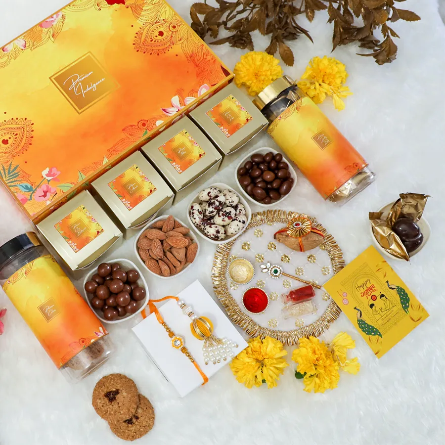 Joyous Rakhi Goodness Hamper featuring a Rakhi, chocolates, cookies, and a Pooja Thali.