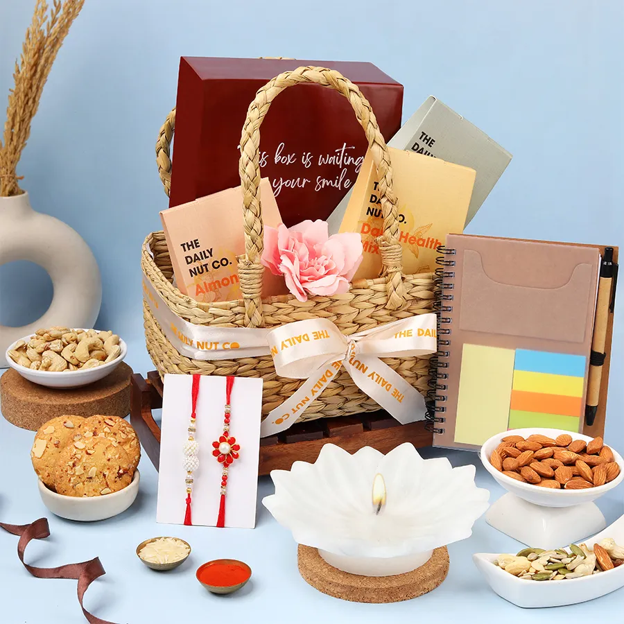 Delightful Rakhi Gift Hamper with nuts, cookies, notepad, candle, and Rakhis for celebrating the festival of Raksha Bandhan.