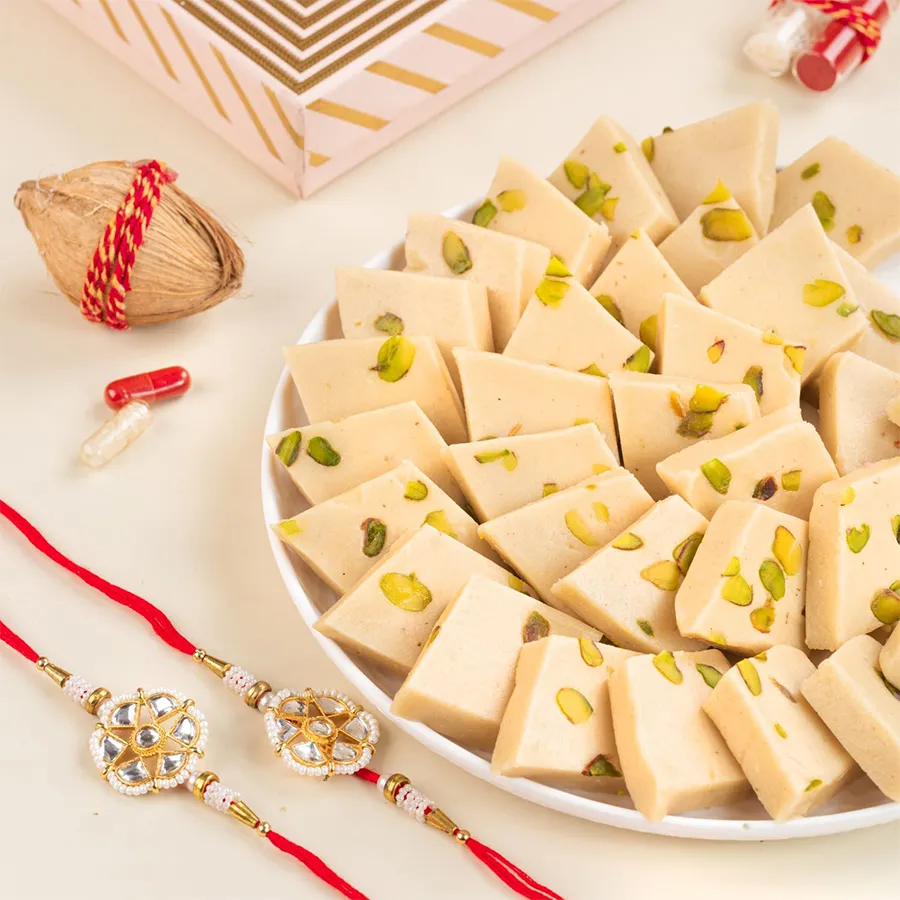 Sweet Festivities Gift Bundle with pistachio kaju katli, rakhis, and greeting card for festive celebrations.