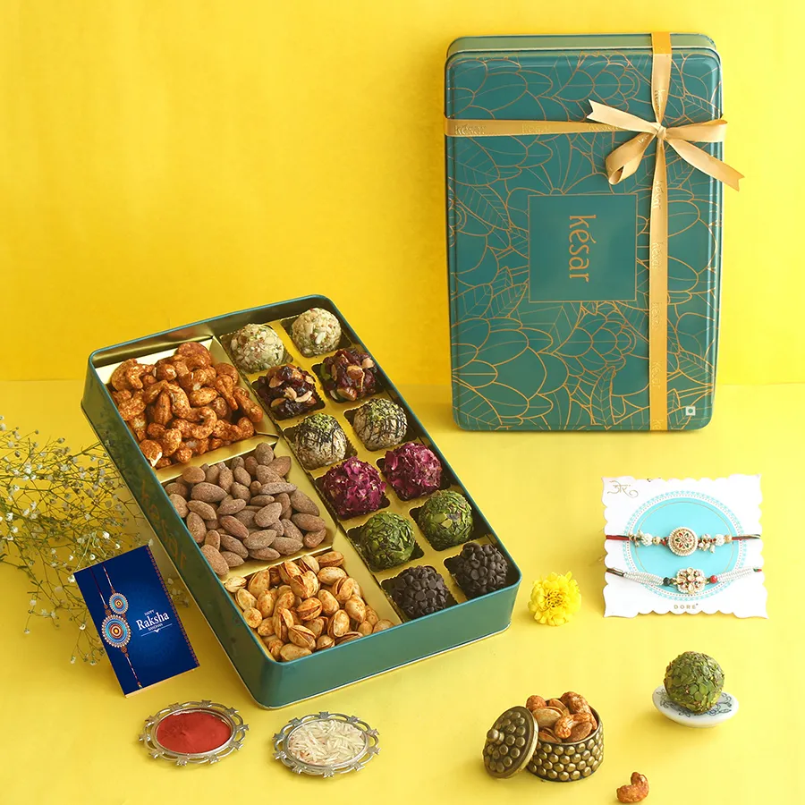 Luscious Rakhi Treats Gift Box featuring Rajputana Rakhis, assorted Laddoos, and crunchy snacks for a festive celebration.