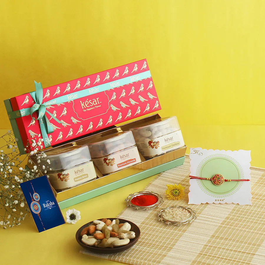 Heartfelt Nutty Rakhi Box with nuts, a red flower Rakhi, and greetings card.
