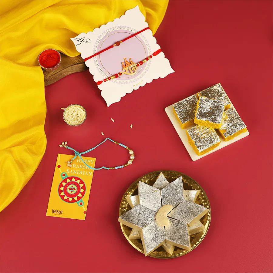 Rakhi Joyful Treats Set includes Rakhis, Kaju Katli, Moong Thal, Roli Chawal, and a festive card for Raksha Bandhan.