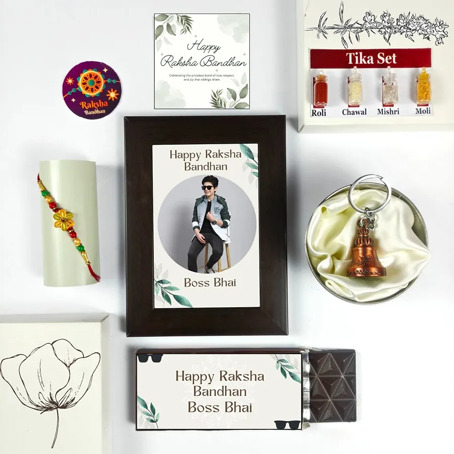 Celebrate Brotherly Love Rakhi Bundle with Rakhi, chocolate bar, photo frame, greeting card, guardian bell, and tika set for Raksha Bandhan.