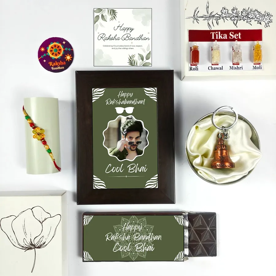 Bhai's Day Rakhi Celebration Gift Box featuring a Cool Bhai Rakhi, chocolate, photo frame, greeting card, guardian bell, and tika set.