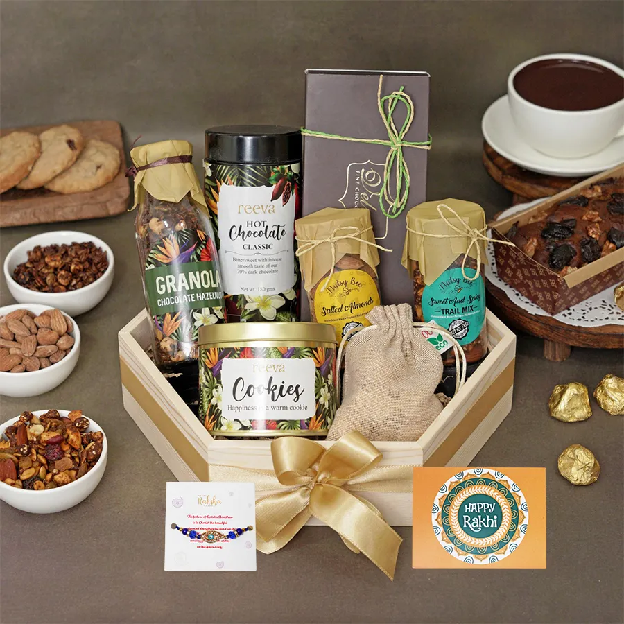 Festive Rakhi gourmet snack bundle featuring granola, cookies, and a Rakhi card for celebration.