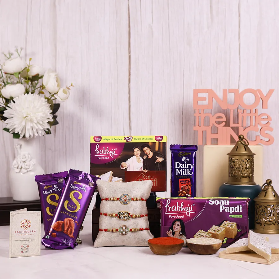 Stone Rakhi & Sweet Treats Combo featuring rakhis, Haldiram sweets, Dairy Milk chocolates, and a reusable gift box.
