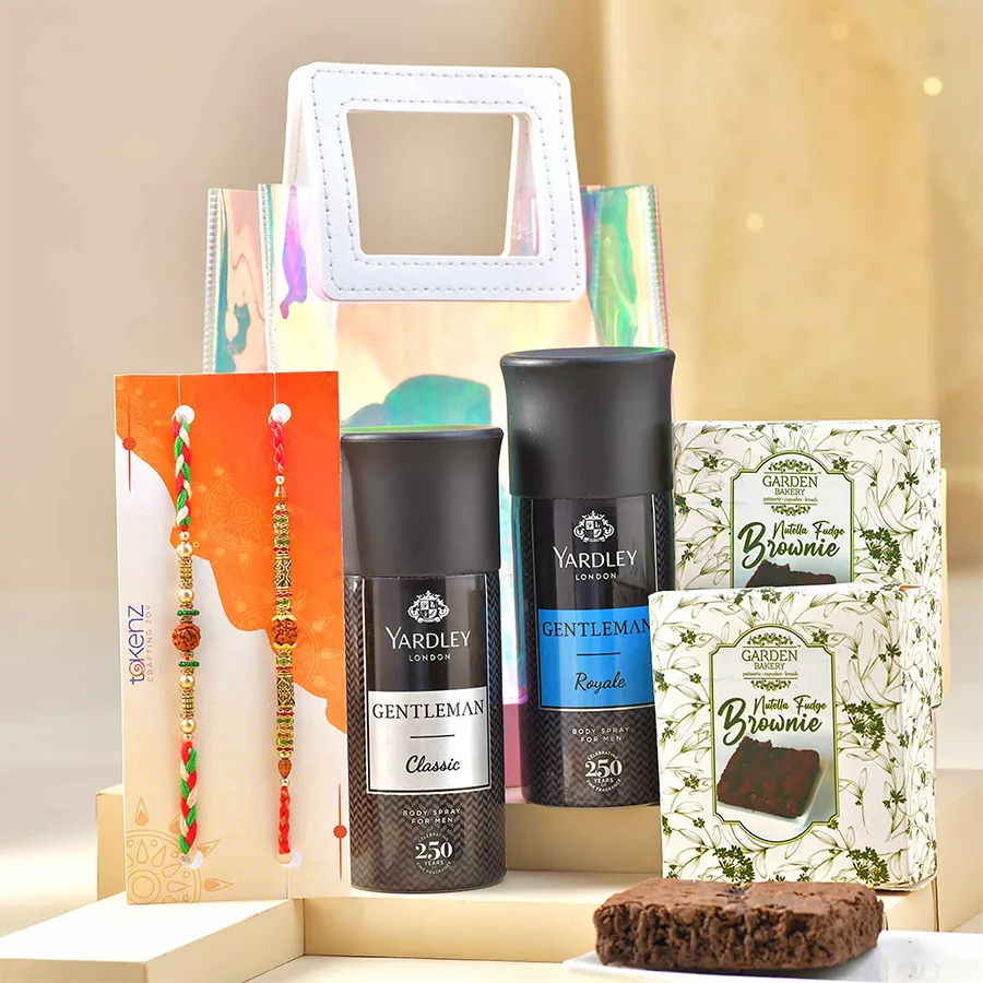 Classy Rakhi & Treats Ensemble with Rudraksh, two Yardley body sprays, Nutella brownies, and a transparent gift bag.