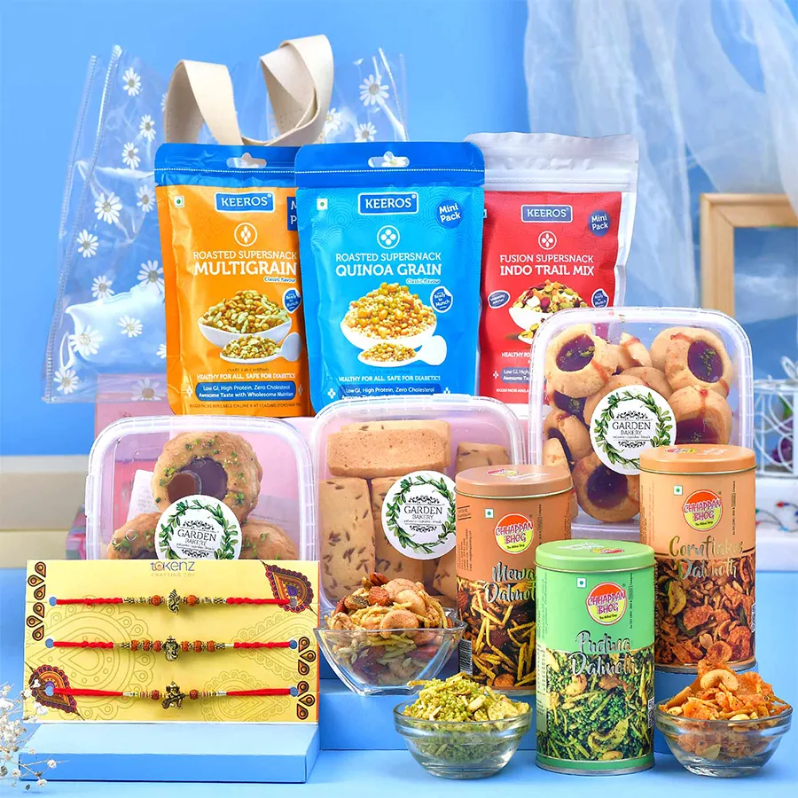 Ganesha Rakhi Gourmet Treat Hamper featuring Rakhis and assorted snacks.