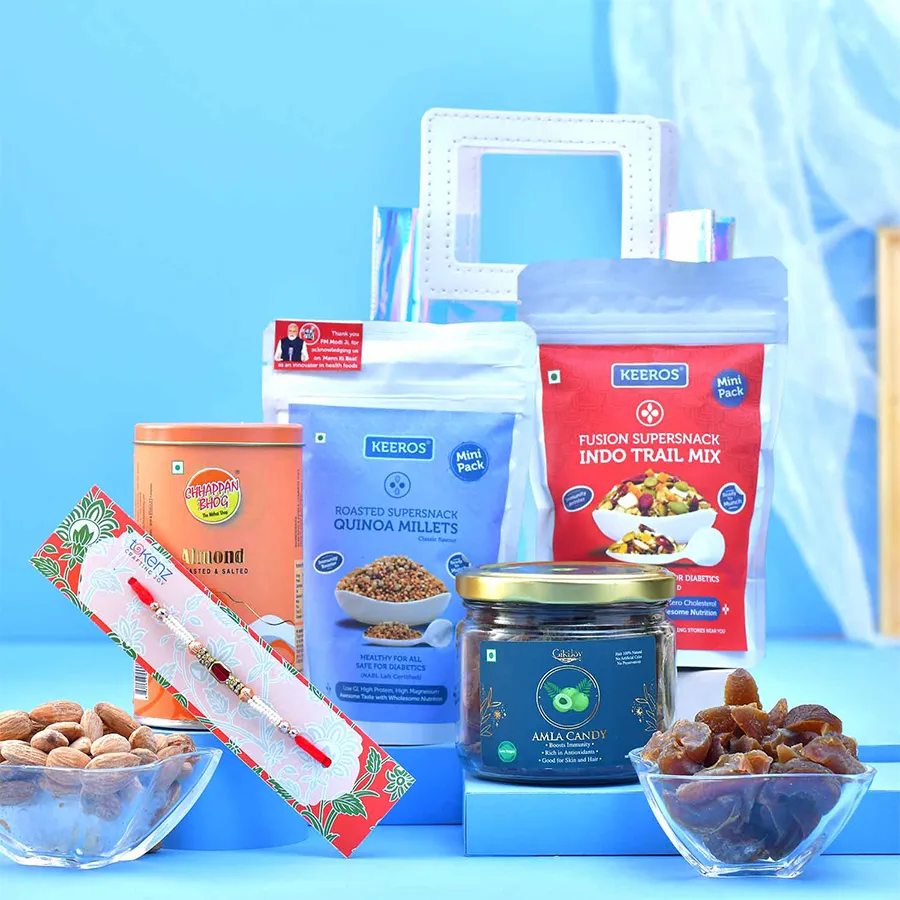 Designer Rakhi & Healthy Treat Pack featuring a designer Rakhi and assorted snacks in a transparent gift bag.