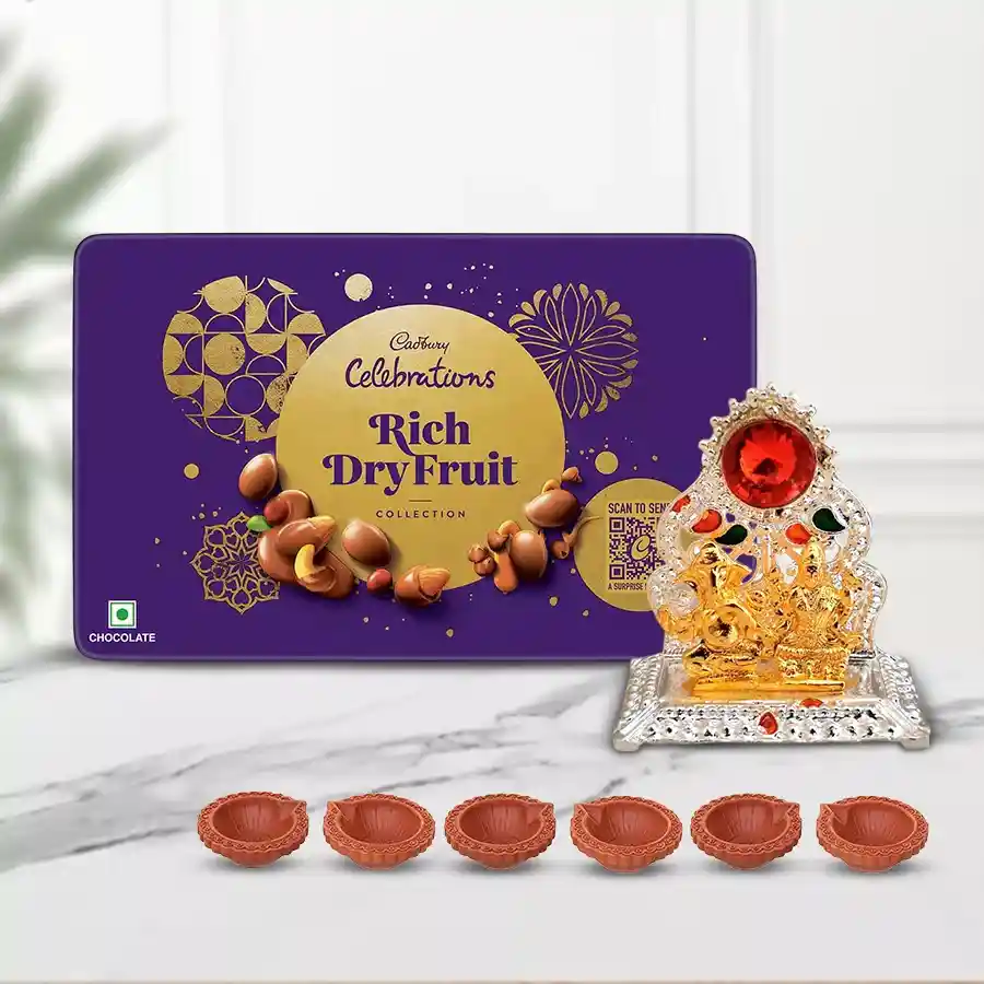 Diwali gift hamper featuring Cadbury Rich Dry Fruits Tin, Laxmi Ganesh idol, and six decorative mud diyas