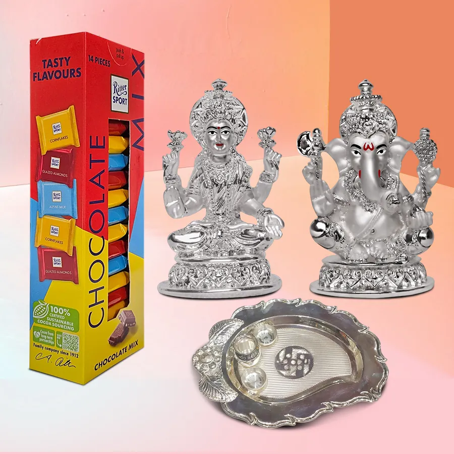 Elegant gift hamper featuring 9 Ritter Sport Mini Imported Chocolates, a silver-plated Ganesh Laxmi idol, and a sleek paan-shaped silver pooja thali.