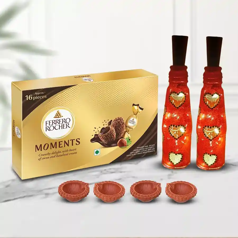 Exclusive Diwali gift hamper featuring Ferrero Rocher chocolates, decorative LED art lamps, and designer mud diyas arranged beautifully.
