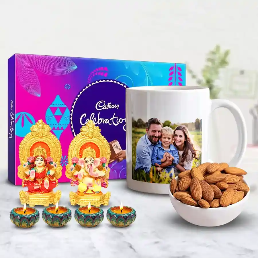 Attractive Ganesh Laxmi idol gift set with personalized coffee mug, Cadbury chocolates, almonds, and decorative wax diyas for Diwali celebration.