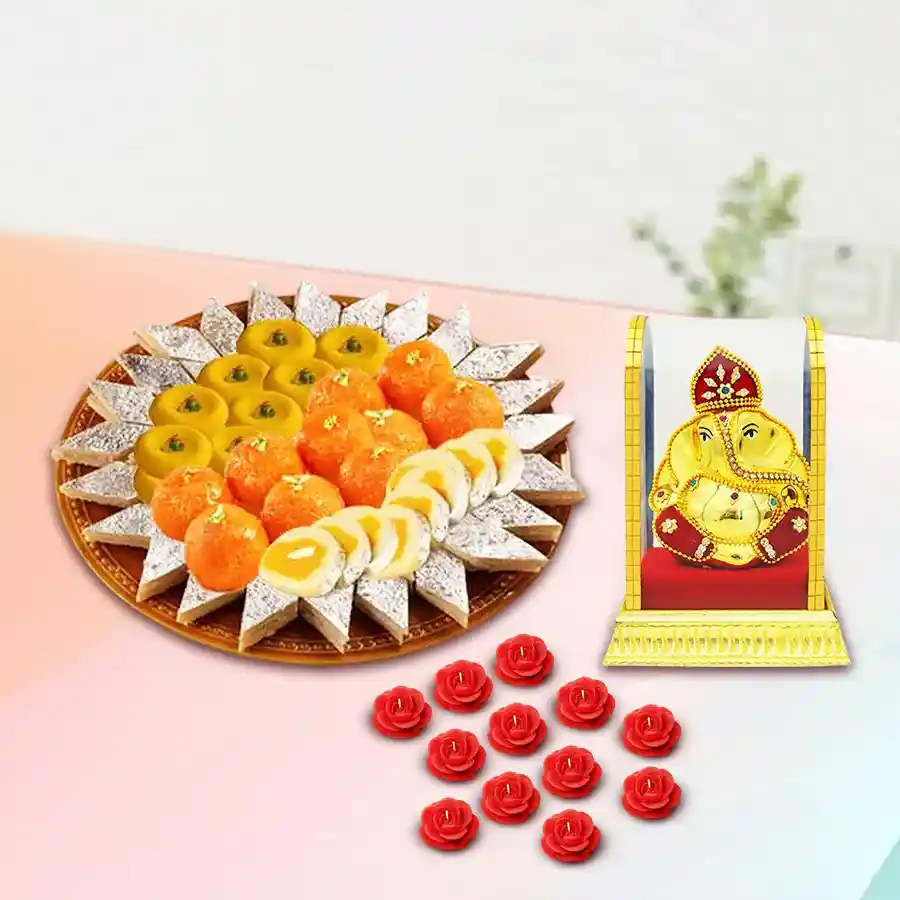 Pious Vighnesh Ganesh Idol with Bhikarams Sweets Platter and Candle Set displaying an intricately designed Ganesh statue, an assortment of Indian sweets, and decorative candles arranged beautifully.
