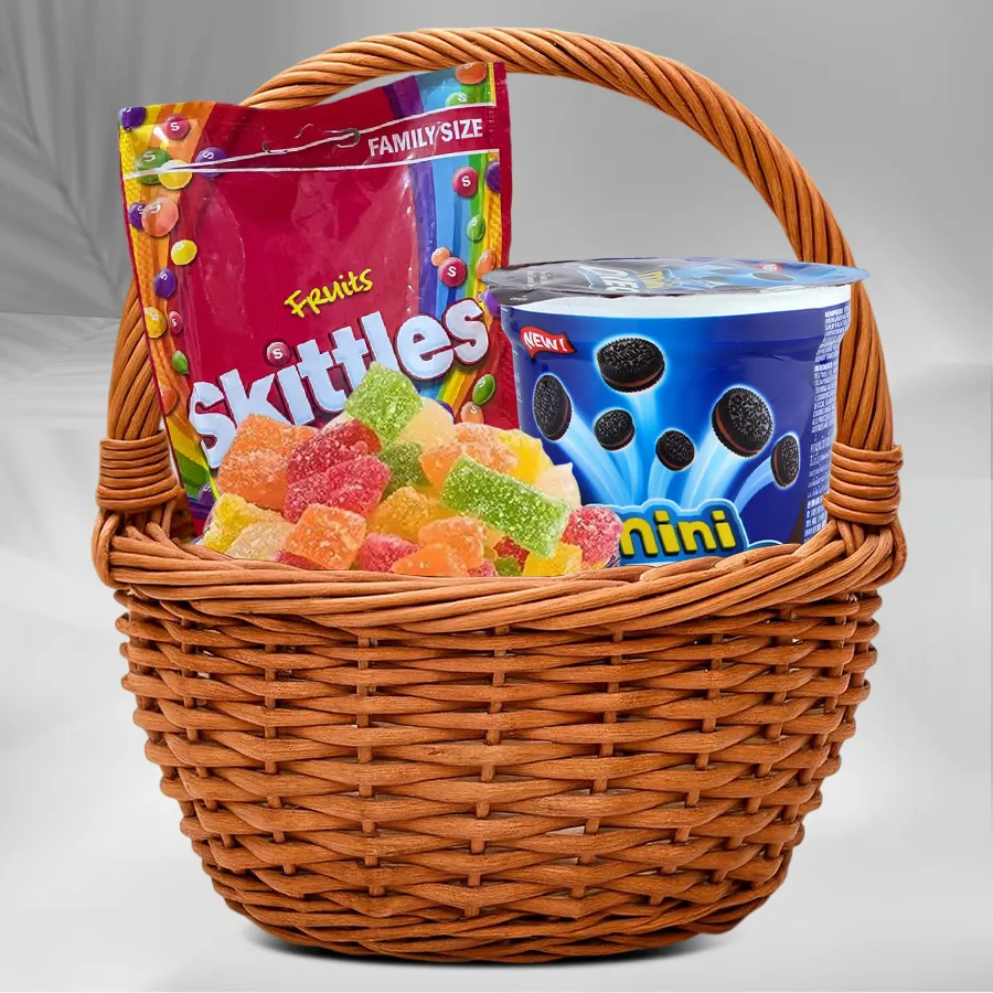 Colorful basket filled with Birthday Chocolates, Skittles, Cadbury Mini Oreos, fruit jellies, and a birthday card.