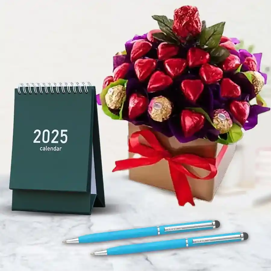 Heart-shaped handmade chocolates with Ferrero Rocher, elegant ballpoint pens, and a stylish desk calendar in a decorative arrangement.